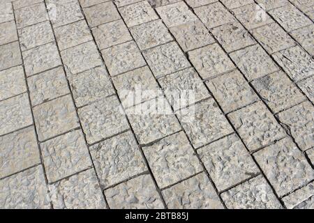 Old paving stones on the sidewalk as a background Stock Photo