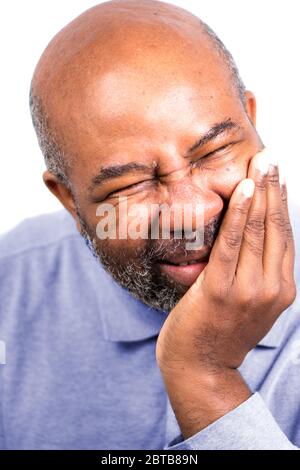 African American Man having tooth ache touching cheek.  Senior with toothache. Isolated on white background Stock Photo