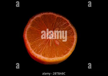 Sliced orange isolated on black background. Fruit chips. Stock Photo