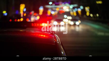 police car lights in night city with selective focus and bokeh Stock Photo