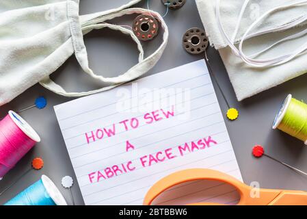 How to sew a fabric face mask, flat lay arrangment of face mask and sewing equipment for making mask Stock Photo