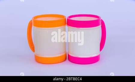 Two colorful plastic coffee mugs on a white background Stock Photo