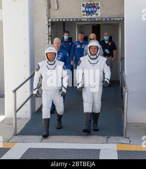Cape Canaveral, United States of America. 23 May, 2020. NASA astronauts Douglas Hurley, left, and Robert Behnken, wearing SpaceX spacesuits, depart the Neil Armstrong Operations and Checkout Building for Launch Complex 39A during a dress rehearsal prior to the Demo-2 mission launch at the Kennedy Space Center May 23, 2020 Cape Canaveral, in Florida. The NASA SpaceX Demo-2 mission is the first commercial launch carrying astronauts to the International Space Station. Credit: Brandon Garner/NASA/Alamy Live News Stock Photo