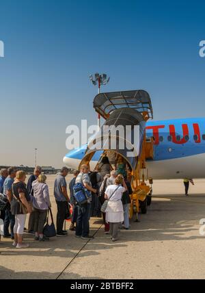 VERONA, ITALY - SEPTEMBER 2018: Passengers queuing to board a TUI Boeing 737 at Verona airport. Stock Photo