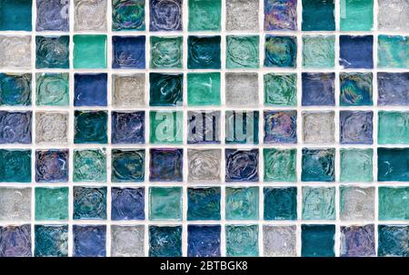 Ceramic mosaic tiles with blue, turquoise and white embossed squares for the decor of the kitchen, bathroom or pool. Stock Photo