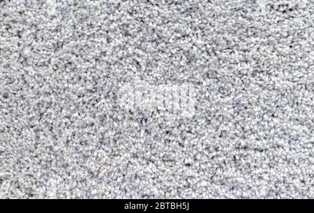 Gray carpet with a long and soft pile. Background with carpet pile. Stock Photo