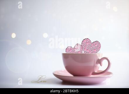 Pink porcelain cup of tea coffee with icons of two pink hearts and word LOVE on white background with circles. Card, poster, mock up. Celebrating, love, anniversary, birthday, valentins concept. Stock Photo