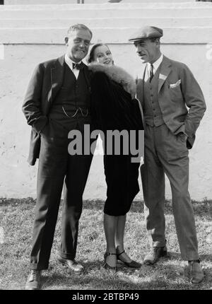 Swedish-born actress Greta Garbo (Retrospective), (born on September 18, 1905, died on April 15 ,1990 at aged 84)    Russian-Swedish film director Mauritz Stiller (1883 - 1928) (right) with Victor Seastrom and Swedish born actress Greta Garbo  (1925).  Photo by Ruth Harriet Louise /  File Reference # 34000-043THA Stock Photo