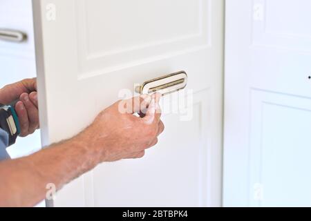 Installation of new cabinet, handyman sets door handles Stock Photo