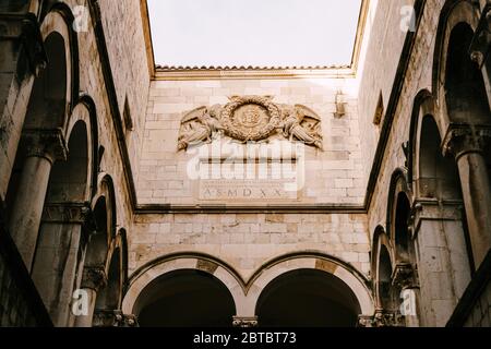 The interior of the Sponza Palace in Dubrovnik, Croatia. Courtyard with columns and open-air arches. Stock Photo
