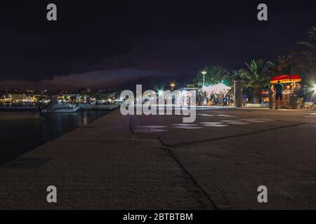 Novalja, Pag Island, Croatia - July 23 2018: Promenade in Novalja at night. People enjoying food and shopping stalls at the waterfront Stock Photo