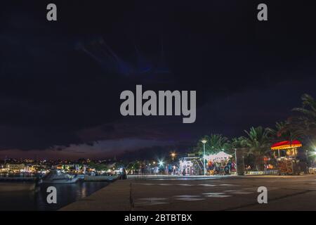 Novalja, Pag Island, Croatia - July 23 2018: Promenade in Novalja at night. People enjoying food and shopping stalls at the waterfront Stock Photo