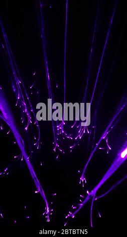 Overlaying wavy lines forming an abstract pattern on a dark background Stock Photo