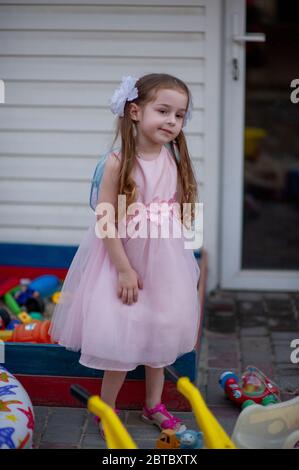 Portrait of a beautiful little girl in a pink dress five years Stock Photo  - Alamy