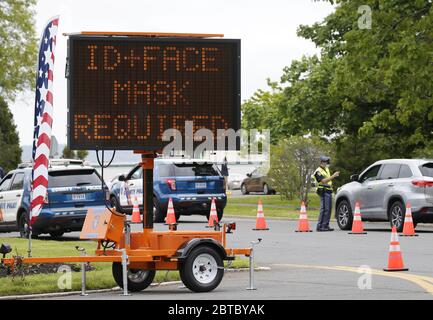 Rye, United States. 24th May, 2020. A digital sign says 'ID   FACE MASK REQUIRED' as Westchester County Police greet people as they enter Rye Playland on Memorial Day Weekend at Rye Playland Beach during the Coronavirus Pandemic in New York City on Sunday, May 24, 2020. More than 5.3 million cases of COVID-19 have been reported worldwide resulting in over 343,000 deaths. Photo by John Angelillo/UPI Credit: UPI/Alamy Live News Stock Photo