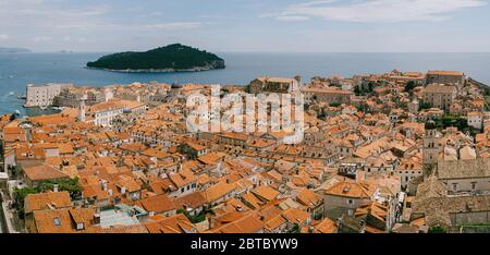 Panoramic view of the whole old city of Dubrovnik. View from the wall to the tiled roofs. Stock Photo