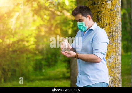 Man using wash hand sanitizer gel dispenser adopting to prevent the ...