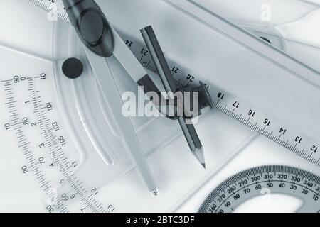 Architectural tools for drafting ruler protractor pair of compasses blue toned Stock Photo