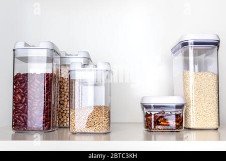 Clear Pantry Containers Filled with Non-Perishable Foods-- Dried Beans, Grains, Dried Peppers, Rice Stock Photo