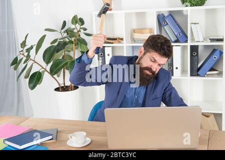 Software license agreement. Destroy laptop. Hateful job. Bad computer. Slow internet connection. Outdated software. Computer lag. Lagging system. Hate office routine. Man bearded crush computer. Stock Photo