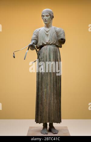 The 470 BCE ancient bronze sculpture The Charioteer of Delphi, also known as Heniokhos (the rein-holder) in the Delphi Archaeological Museum, Greece. Stock Photo