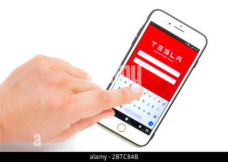 Calgary, Alberta, Canada. May 24, 2020. A person sign in on the Tesla account on a white background. Stock Photo