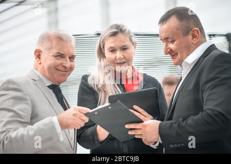 project Manager discussing working documents with colleagues Stock Photo