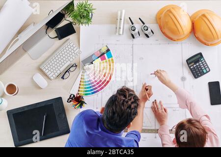 Professional architects working on blueprint of modern house, view from above Stock Photo