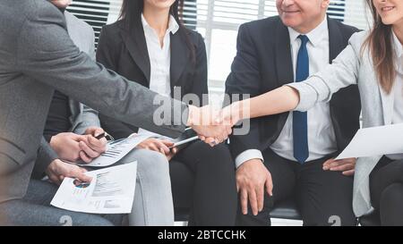 business colleagues shaking hands with each other. Stock Photo