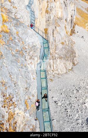 Tourists walking on the Thrill Walk, the cliff pathway located under Birg cableway station at Schilthorn mountain in the Alps, Switzerland Stock Photo