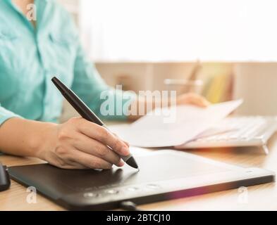 designers hand use mouse pen and computer working on new projects Stock Photo