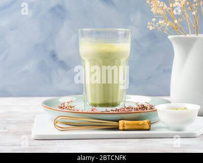 Green matcha tea latte drink in tall glass Stock Photo