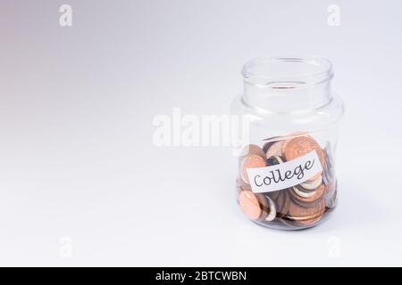 College education savings pennies in a transparent jar with copy space Stock Photo
