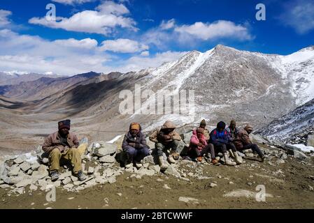 Daily wages workers waiting for transportation near Khardungla Pass at 18,000 feet, Leh Ladakh City, Jammu & Kashmir State, India - September 2018 Stock Photo