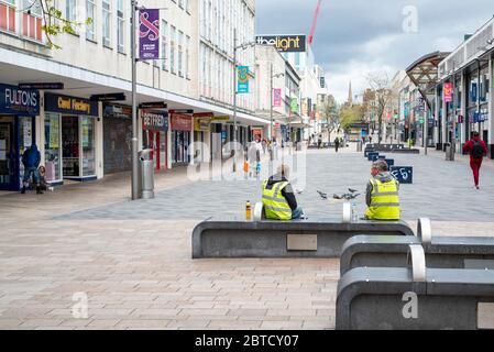 Sheffield UK –  April 30 2020: Essential workers and shoppers  socially distance in Sheffield during the coronavirus Covid-19 lockdown on The Moor Stock Photo