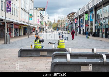 Sheffield UK –  April 30 2020: Essential workers and shoppers  socially distance in Sheffield during the coronavirus Covid-19 lockdown on The Moor Stock Photo