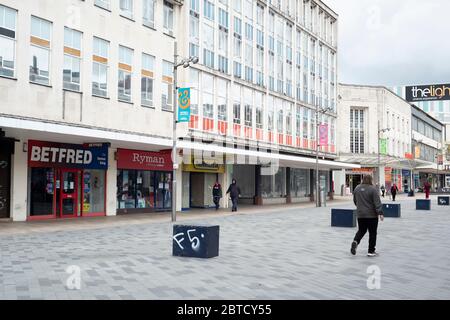 Sheffield UK –  April 30 2020: A few shoppers walk among closed shops - essential and non-essential businesses in Sheffield during the coronavirus Cov Stock Photo