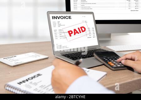 Businessman work Using The Computer Calculating  Invoice In Office Invoice Form and Accountant Checking Invoice Stock Photo