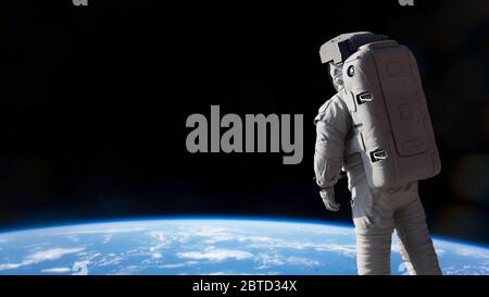 astronaut presenting an empty space in front of planet Earth Stock Photo