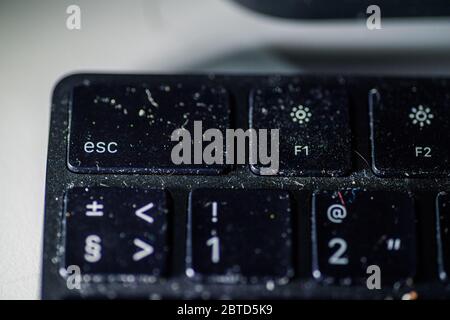 Dusty full with microbes and germs black keyboard risk of infection and disease Stock Photo