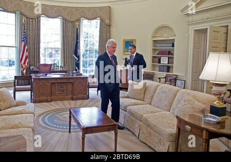 President Barack Obama meets with President Clinton in the Oval Office 4/21/09 Stock Photo