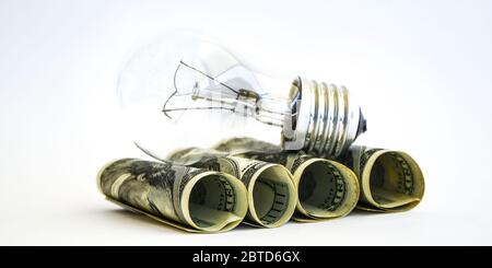 Money saved in different kinds of light bulbs, Lamps on the usd american dollar background Stock Photo