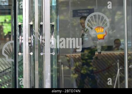 A security personnel is seen past a logo of Royal Dutch Shell Plc at its headquarters building on May 21, 2020 in The Hague, Netherlands. Credit: Yuriko Nakao/AFLO/Alamy Live News Stock Photo