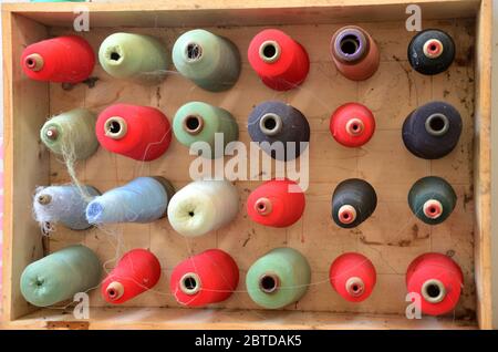 Different colored wire spools on a board Stock Photo