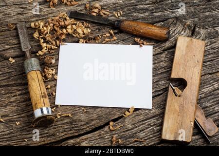 carpenter tools on dark rustic table with blank paper. Stock Photo