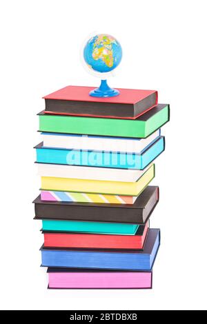 A globe on top of stack of colorful books with different sprayed edges, isolated on white background. Education and travel concept. Stock Photo