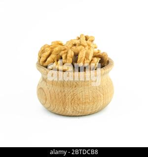 Walnuts in wood bowl close up isolated on white background. Stock Photo