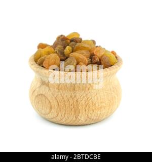 Raisins, sultanas in wood bowl close up isolated on white background. Stock Photo