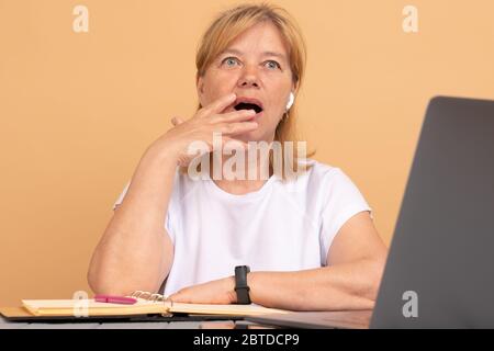 Stressed frustrated senior woman student reading bad email internet news feeling sad tired of study work online, upset about problem, failed exam test Stock Photo