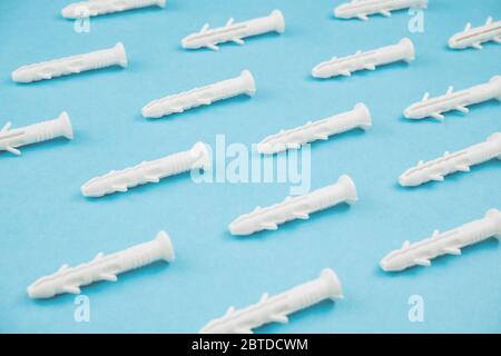 White dowels on blue background. Close up. Stock Photo